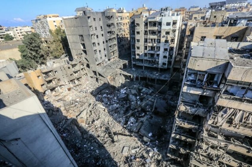 Homes are heavily damaged around buildings levelled by Israeli strikes that targeted and k