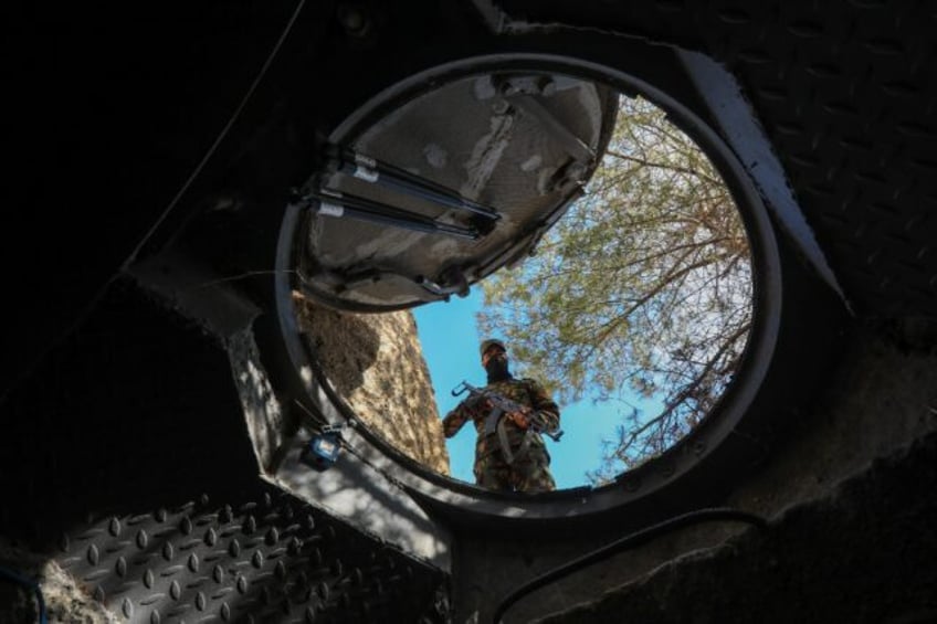 Mountain lair: a soldier looks into a hidden exit from from Maher al-Assad's private offic