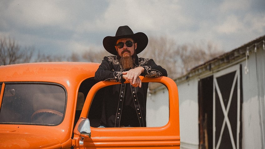 Whey Jennings in front of an orange truck