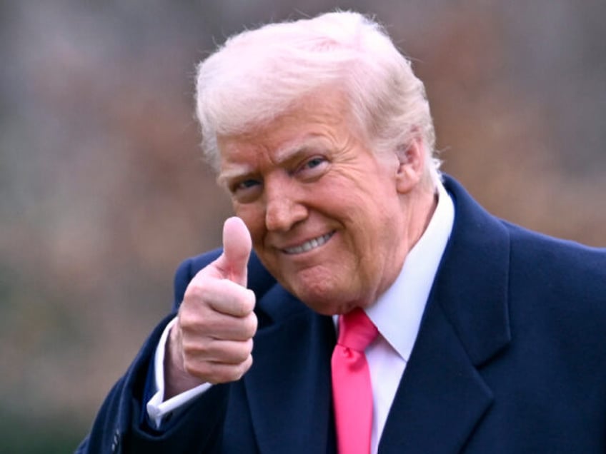 President Donald Trump gives a thumbs-up as he arrives at the White House after speaking a
