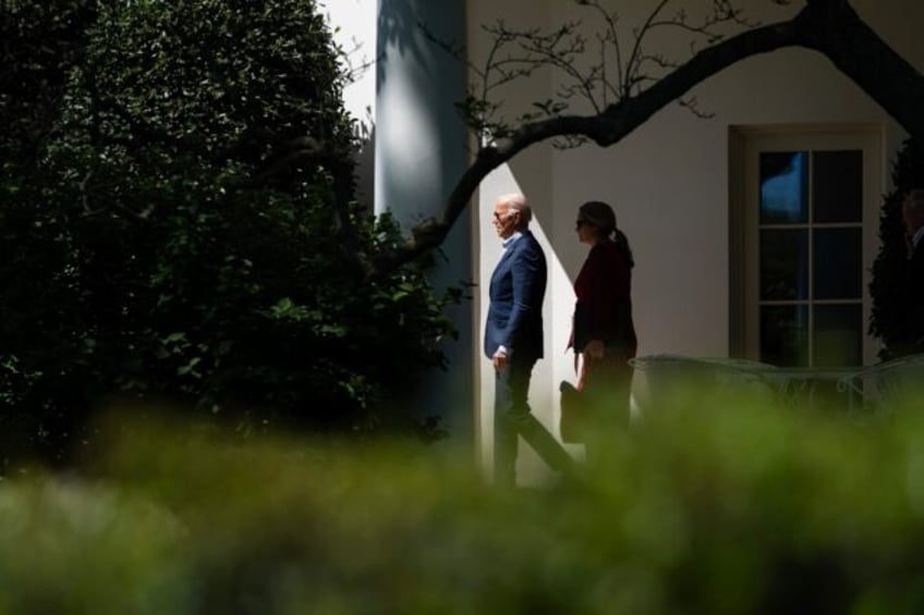 US President Joe Biden and Deputy Chief of Staff Annie Tomasini depart the Oval Office and