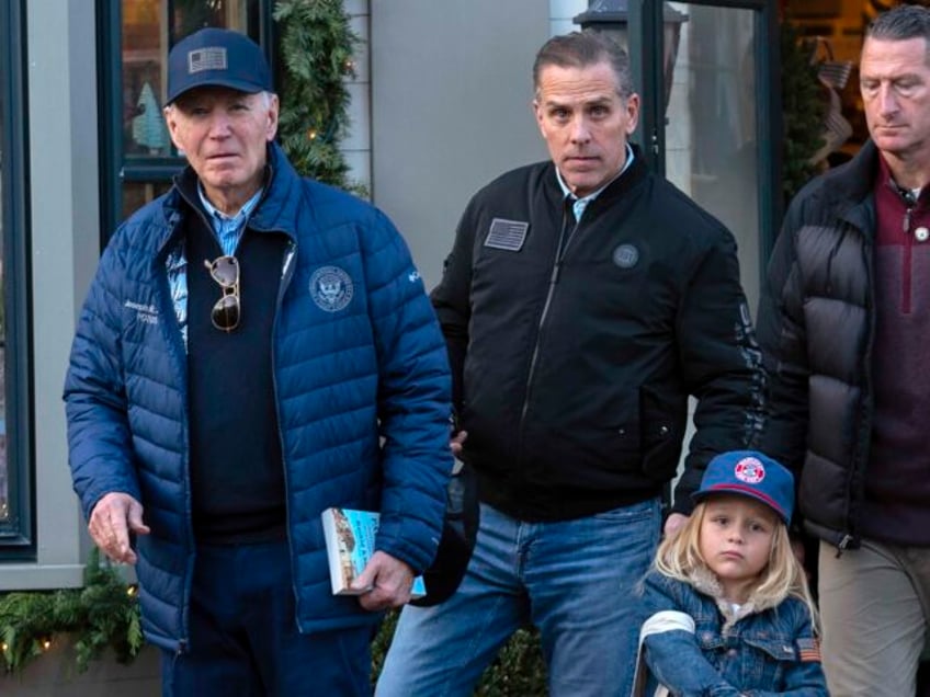 President Joe Biden accompanied by his son Hunter Biden and his grandson Beau leave a book