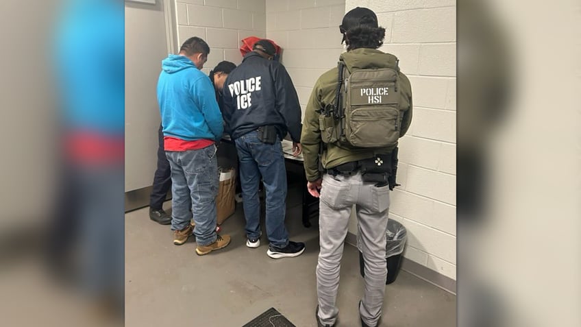 Federal agents detain a man accused of immigration crime