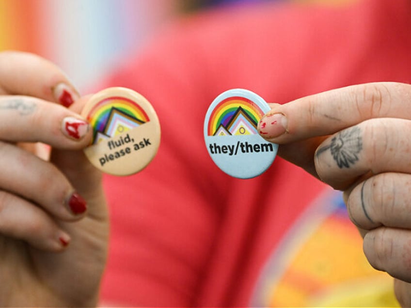 Laramie LGBTQ residen and University of Wyoming Alumni Ray Kasckow holds pins about gender