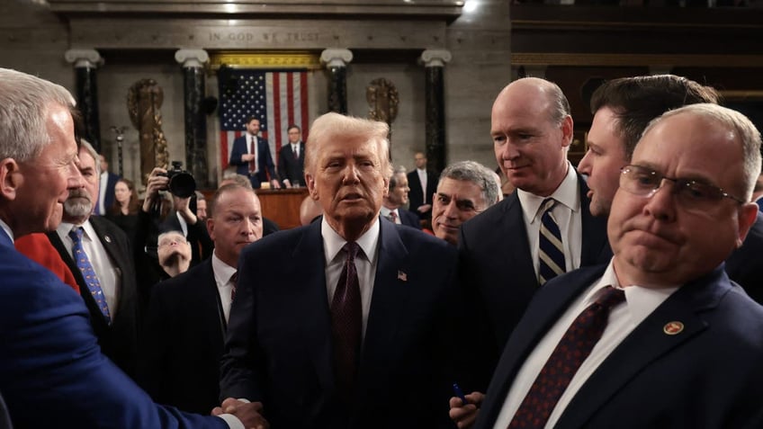 President Donald Trump greets lawmakers as he leaves after addressing a joint session of Congress at the Capitol in Washington, March 4, 2025. (Win McNamee / POOL / AFP) 