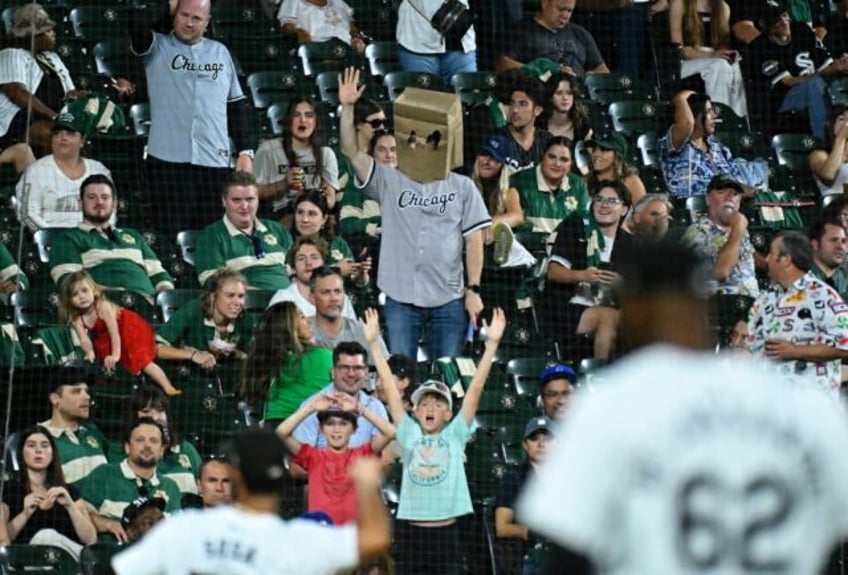 A Chicago White Sox fan wears a paper bag over his head while watching his team, on pace f