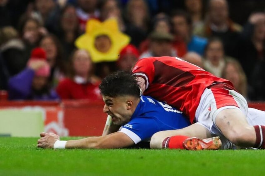 Key score: Italy full-back Lorenzo Pani (under L) dives across the line to score a try in