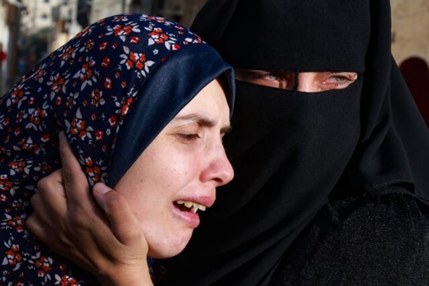 Rania Abu Anza (L) mourns her twin babies Naeem and Wissam, killed in an air strike