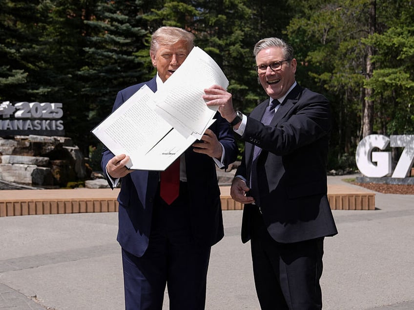 whoops uk pm starmer scoops trumps freshly signed trade deal papers