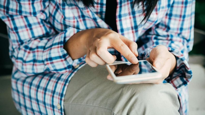 seated person texting