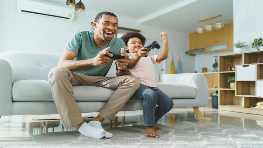 father and son playing game together