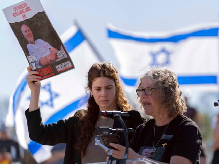 Aviva Siegel, a released hostage, and her daughter Elan holding a photograph of her father