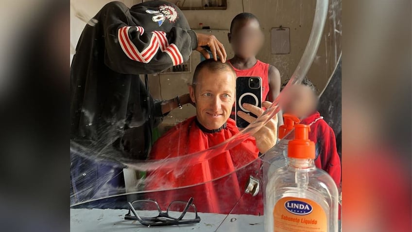 Pastor Beau Shroyer getting a haircut in Africa recently