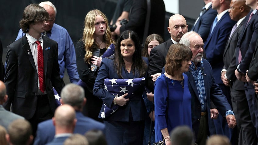 Kelly Weeks, the widow of slain Deputy U.S. Marshal Thomas Weeks Jr., glances over at attendees of her husband's memorial service