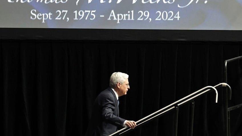 Attorney General Merrick Garland climbs the stairs to the lectern to speak during a memorial service for slain U.S. Marshal Thomas Weeks Jr