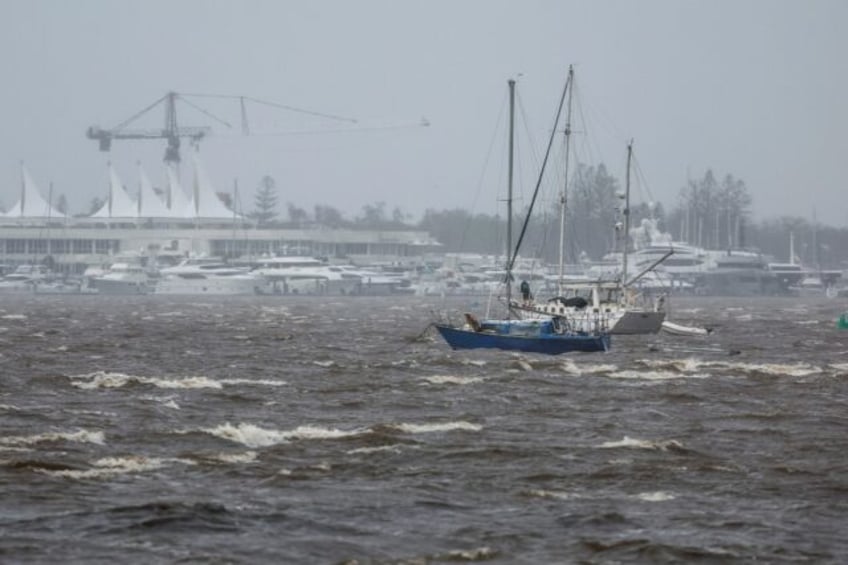 A man stands on a yacht off Australia's storm-battered Gold Coast