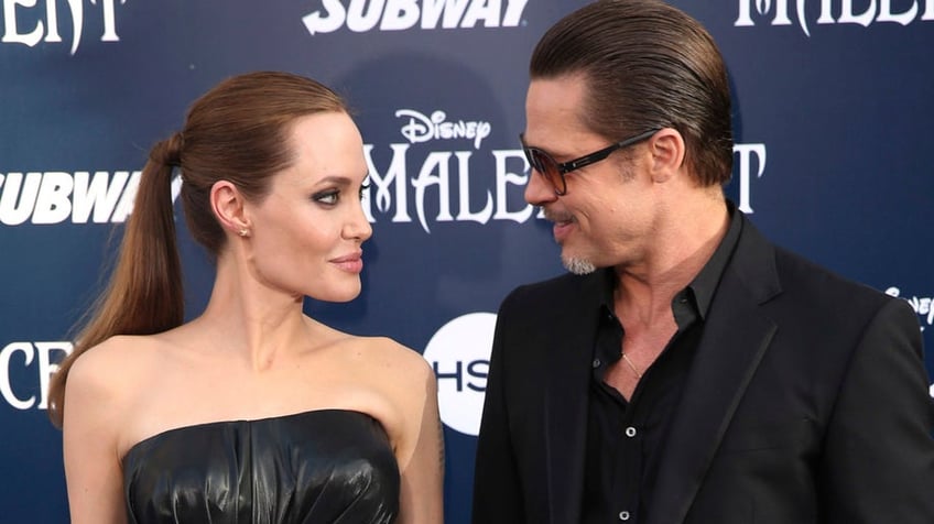 FILE - In this May 28, 2014 file photo, Angelina Jolie and Brad Pitt arrive at the world premiere of "Maleficent" in Los Angeles. Angelina Jolie Pitt and Brad Pitt have reached an agreement to handle their divorce in a private forum and will work together to reunify their family, the actors announced in a joint statement Monday, Jan. 9, 2017. (Photo by Matt Sayles/Invision/AP, File)