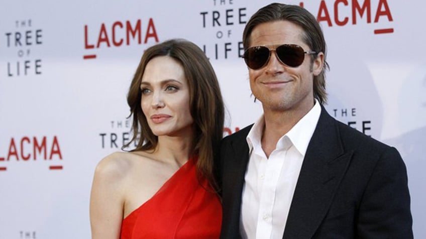 Cast member Brad Pitt and actress Angelina Jolie pose at the premiere of "The Tree of Life" at LACMA in Los Angeles May 24, 2011. The movie opens limitedly in the U.S. on May 27. REUTERS/Mario Anzuoni (UNITED STATES - Tags: ENTERTAINMENT)
