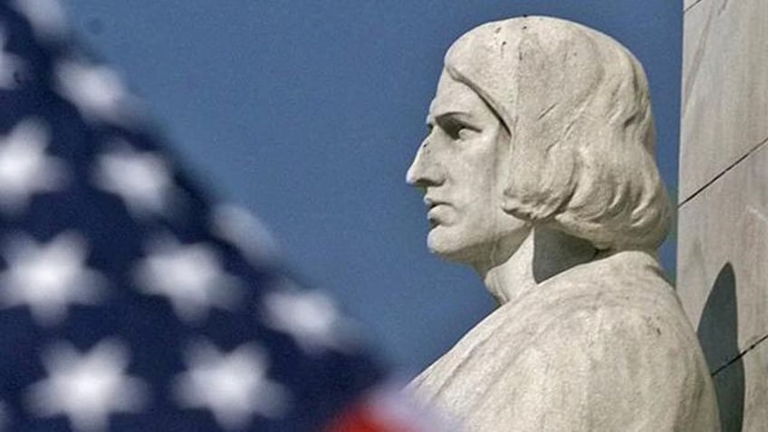 An American flag flies near the Christopher Columbus statue