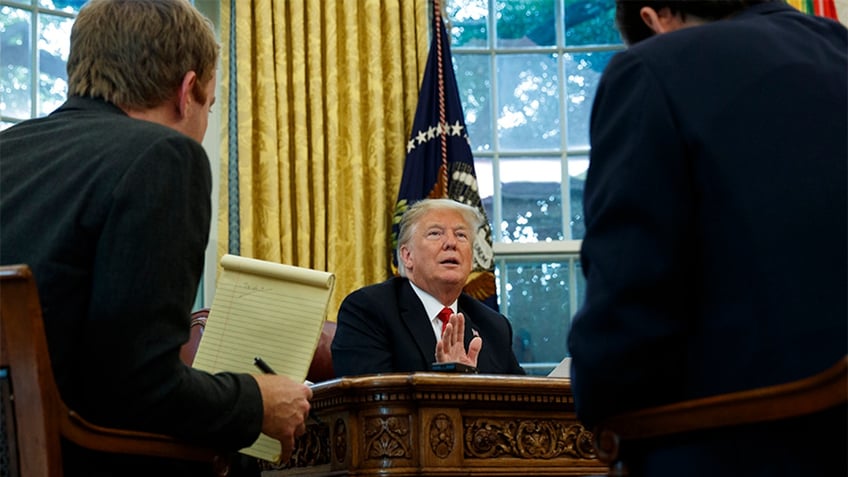 President Donald Trump speaks during an interview with The Associated Press in the Oval Office of the White House on Tuesday in Washington