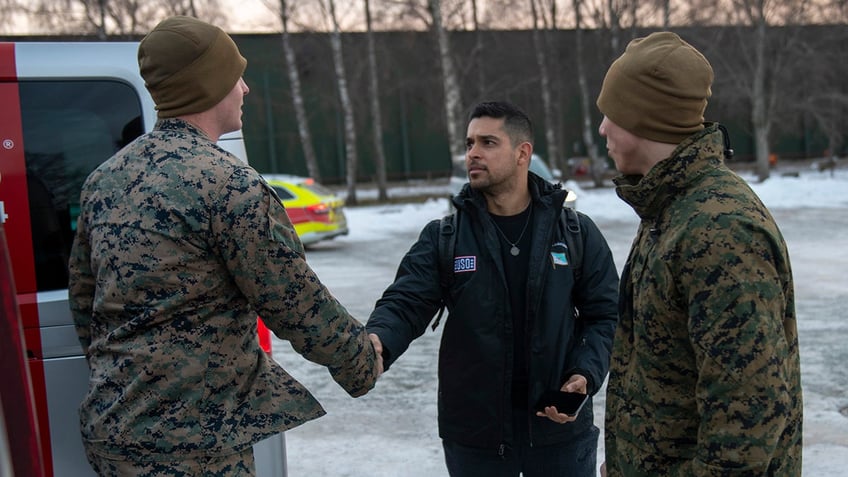 Wilmer Valderrama shaking hands with a soldier.