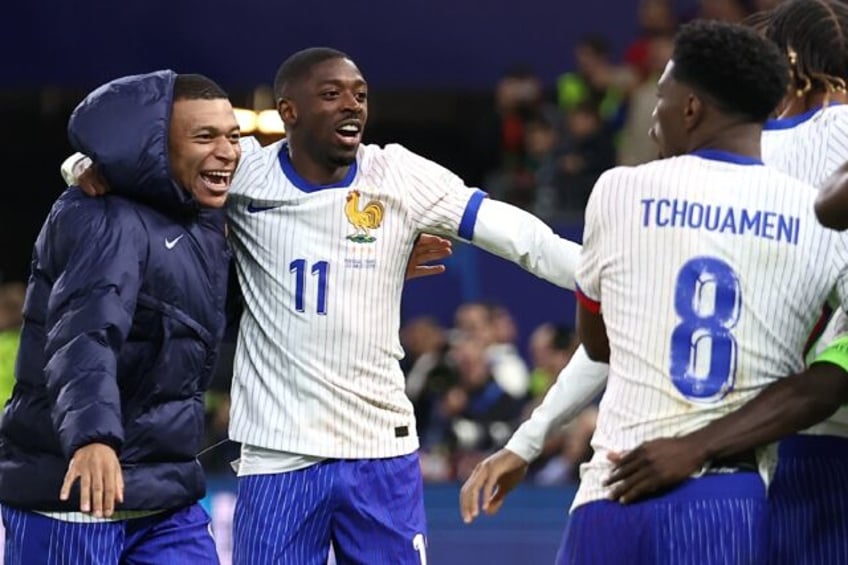 Kylian Mbappe celebrates with Ousmane Dembele after France beat Portugal on penalties in F