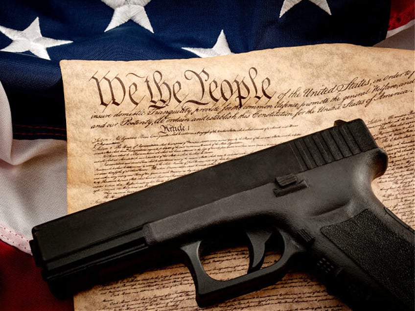 The second amendment and gun control in america concept with a handgun and the american co