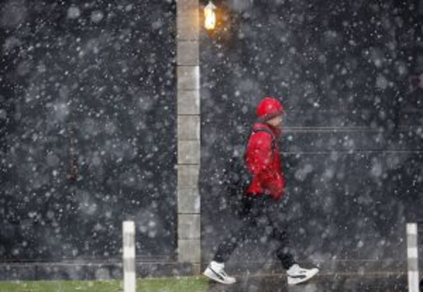 Winter storm snarls East Coast travel; snow forecast downgraded