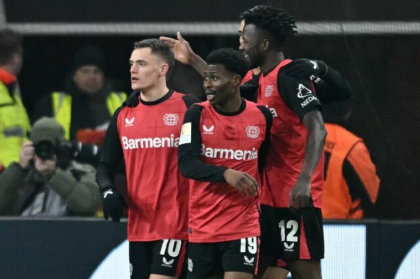 Bayer Leverkusen midfielder Florian Wirtz (L) scored two goals and laid on another against