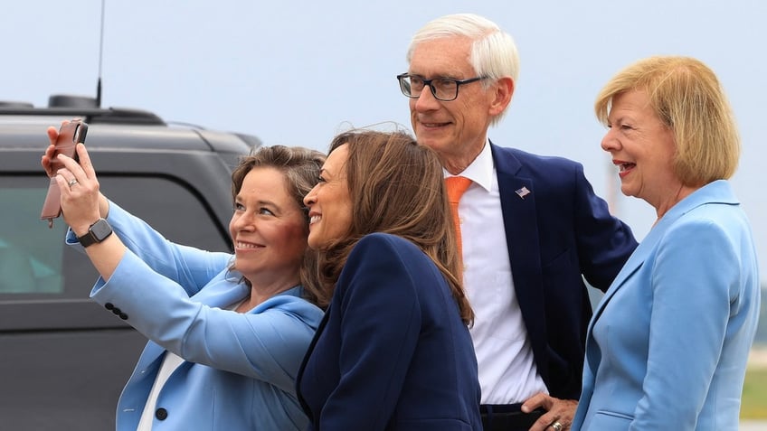 Vice President Kamala Harris, the Democratic presidential candidate, poses for a picture with Wisconsin Lt. Gov. Sara Rodriguez, Wisconsin Gov. Tony Evers and U.S. Sen. Tammy Baldwin at Milwaukee Mitchell International Airport July 23, 2024, in Milwaukee. 