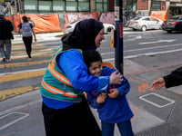 With a vest and a voice, helpers escort kids through San Francisco’s broken Tenderloin streets