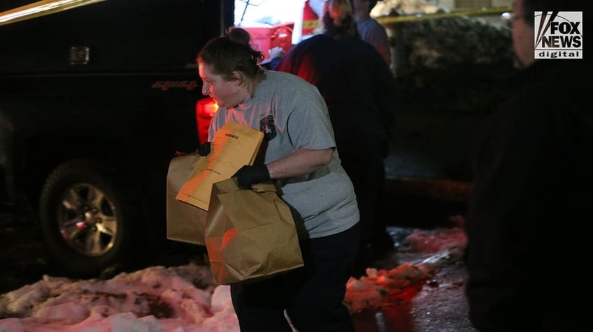 Investigators carry boxes out of Kohberger's Pullman apartment