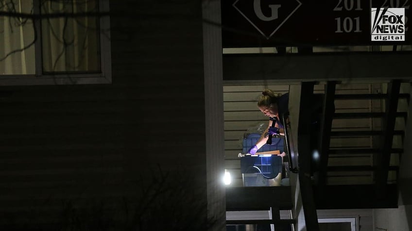 Investigators carry boxes out of Kohberger's Pullman apartment