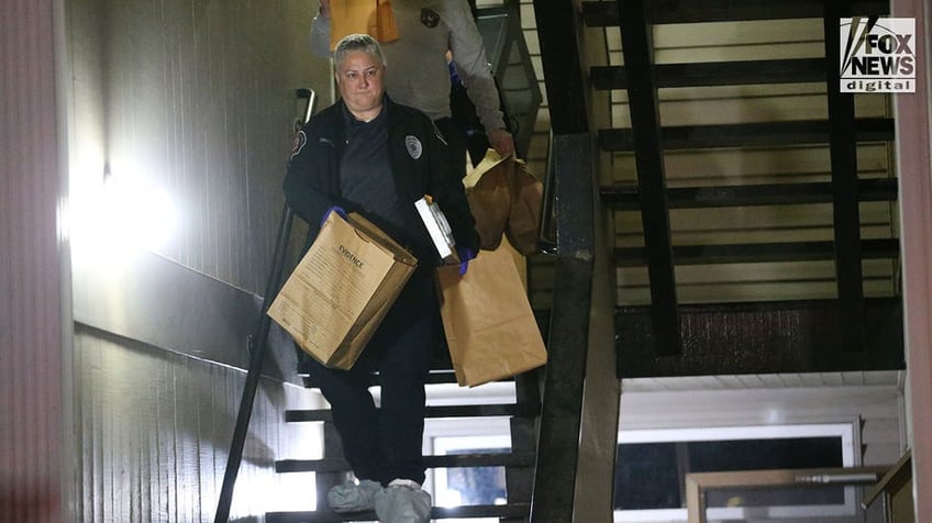 Investigators carry boxes out of Kohberger's Pullman apartment