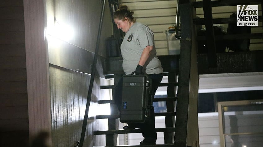 Investigators carry boxes out of Kohberger's Pullman apartment