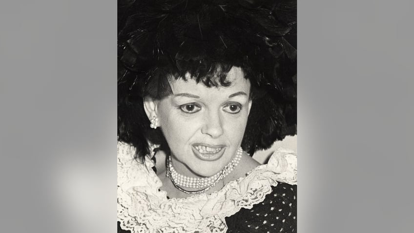 A close-up of Judy Garland wearing a ruffled dress