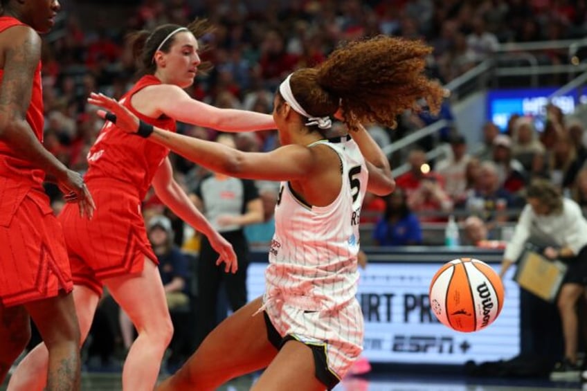 Chicago's Angel Reese (right) is fouled by Indiana's Caitlin Clark (center) in their seaso