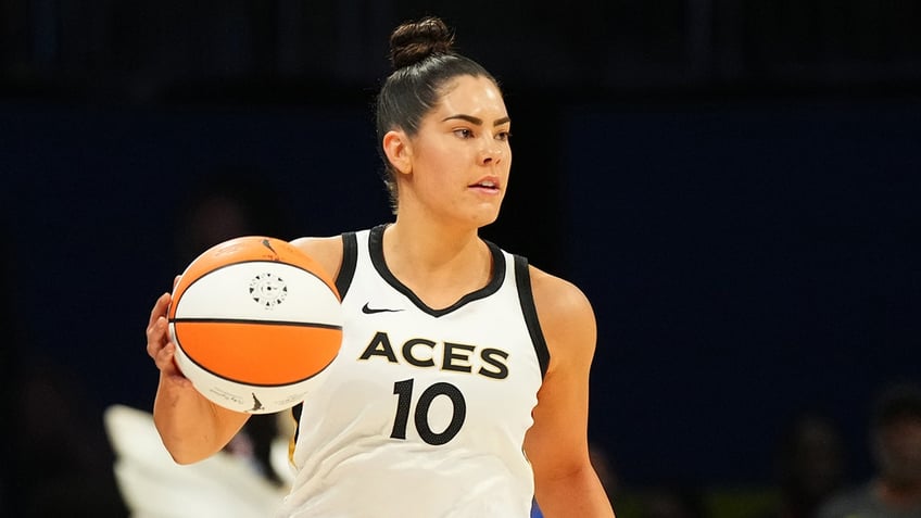 Kelsey Plum dribbles ball