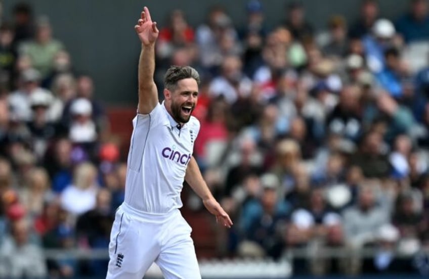 Got him: England's Chris Woakes celebrates having Sri Lanka's Angelo Mathews lbw for a duc