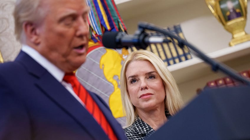 Pam Bondi looks on while Trump speaks at her swearing in ceremony