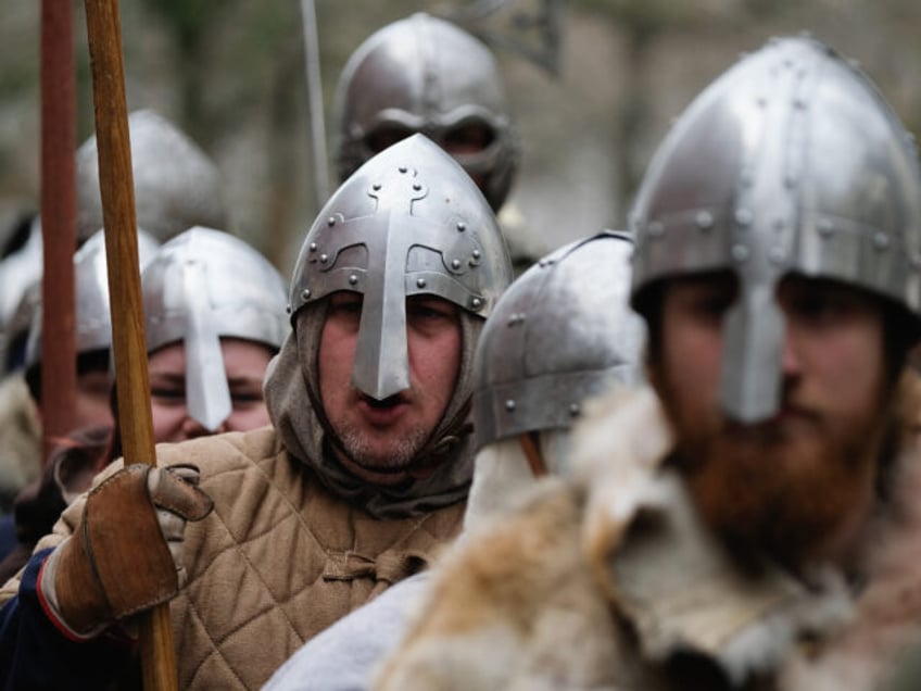 YORK, ENGLAND - FEBRUARY 17: Re-enactors representing the rival armies of the Vikings and Anglo-Saxons march through York City during the Jorvik Viking Festival on February 17, 2018 in York, England. The annual week-long Jorvik Viking Festival held in York is recognised as the largest event of its kind in …