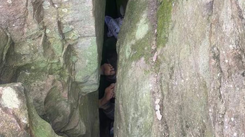 Woman stuck in between boulders in Australia