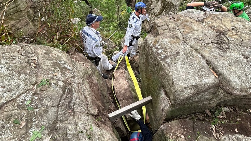 Woman saved after being trapped in between boulders