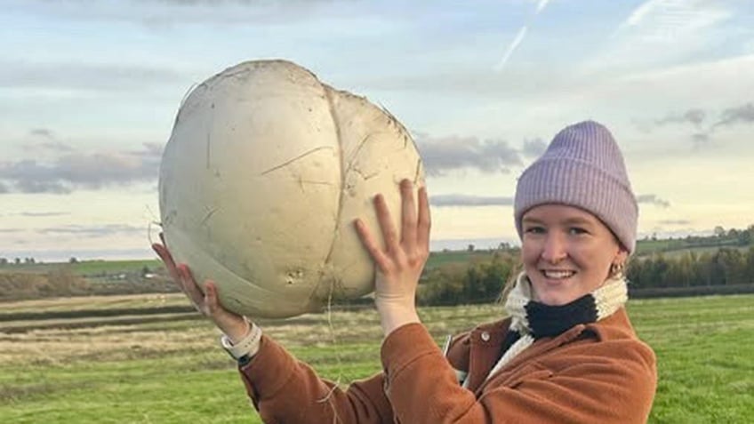 woman holding giant mushroom