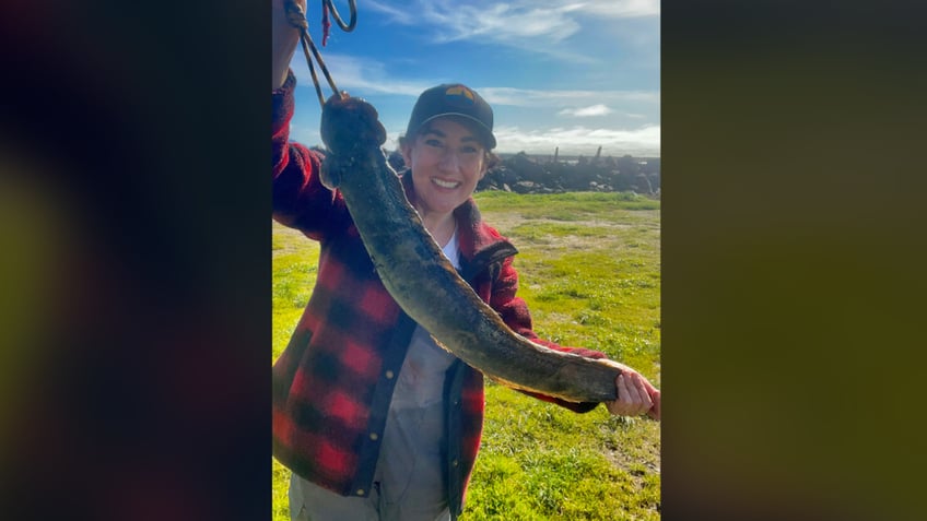 Woman smiling and holding fish