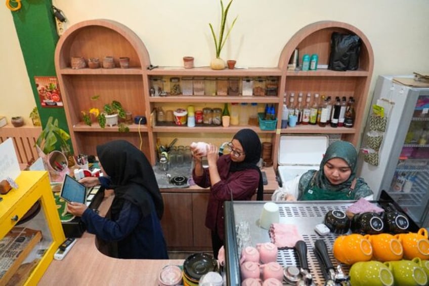 Morning Mama owner Qurrata Ayuni (R) says her Banda Aceh cafe is the only one run by a wom