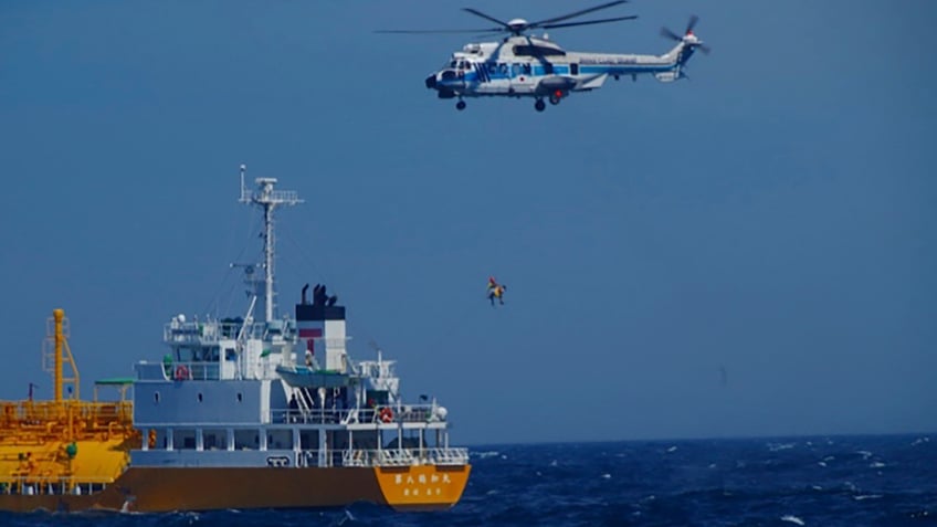 Woman is airlifted by a coast guard helicopter