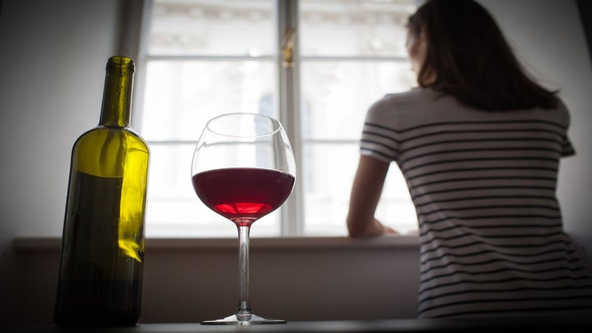 woman turning away from beer and wine