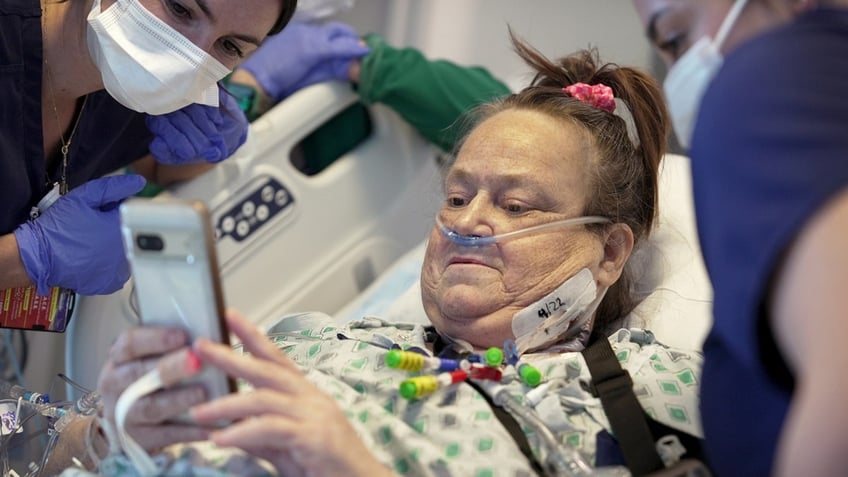 Lisa Pisano shows two nurses photos of her dog after her surgeries at NYU Langone Health in New York.