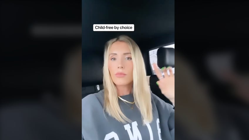 Woman talking at camera in TikTok video.